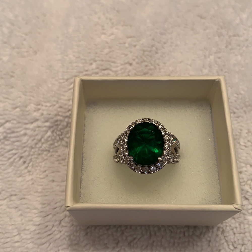 White gold plated ring with green center stone